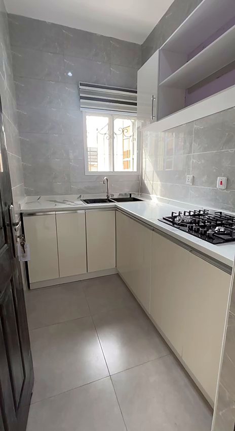 Fitted kitchen with gas hob and white cabinets